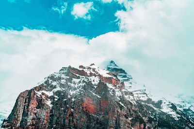 Low angle view of snowcapped mountain against sky