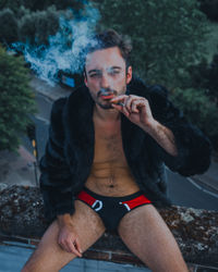 Young man smoking cigarette