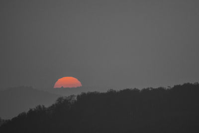Scenic view of moon against sky at sunset