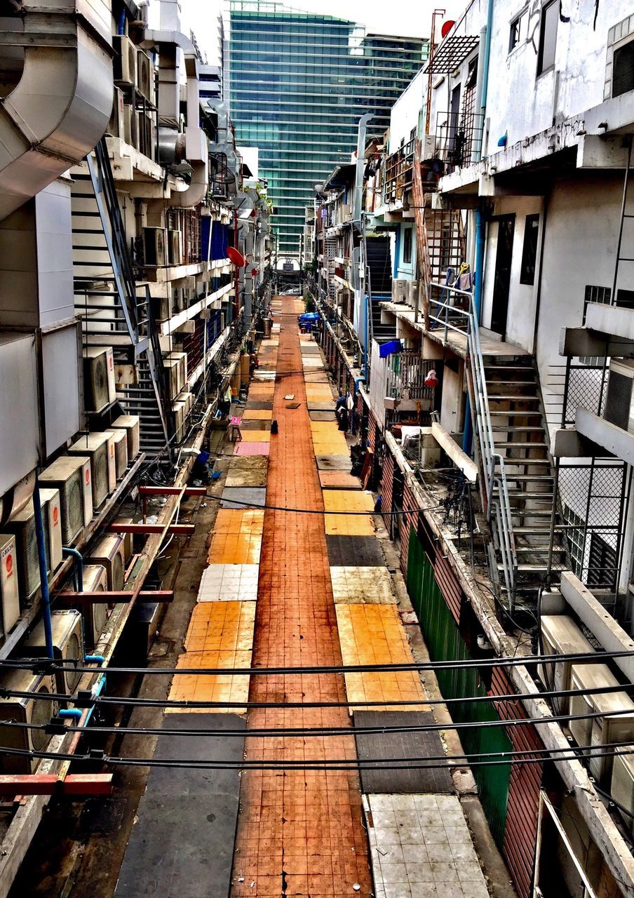 architecture, built structure, building exterior, transportation, diminishing perspective, the way forward, high angle view, city, railroad track, vanishing point, incidental people, day, in a row, city life, railing, building, mode of transport, rail transportation, narrow, public transportation