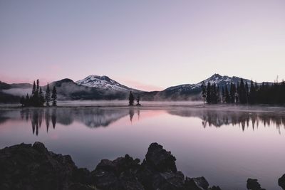 Scenic view of lake and mountains against clear sky