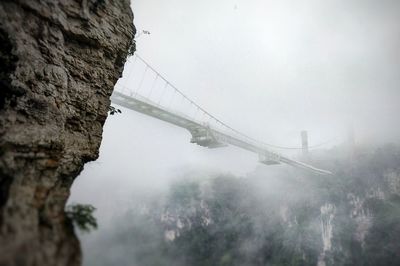 Low angle view of bridge in foggy weather