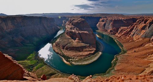 Panoramic view of horseshoe bend canyon rock formations against sky