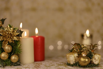 Close-up of christmas decorations with candles on table