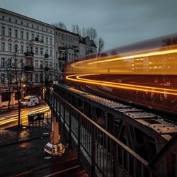 Blurred motion of train in city against sky