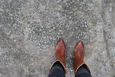 Low section of woman wearing cowboy boots