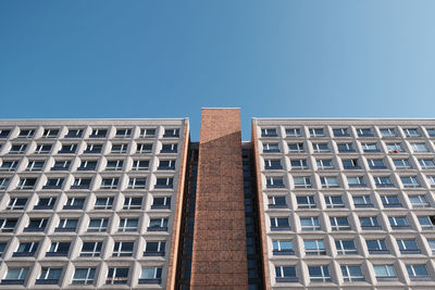 Low angle view of modern building against clear blue sky