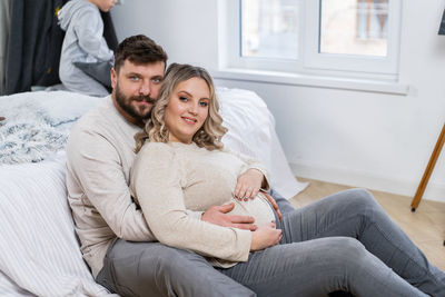 Portrait of young couple sitting at home