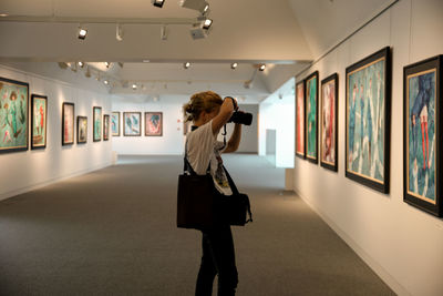 Rear view of woman standing in museum