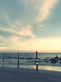 Scenic view of beach against sky during sunset