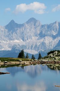 Scenic view of lake and mountains against sky