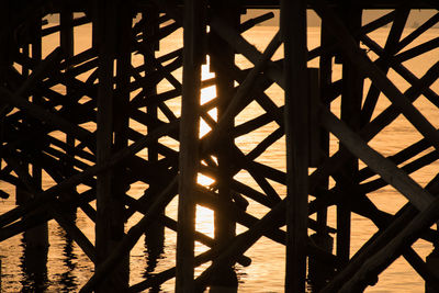 High angle view of silhouette railing against sea