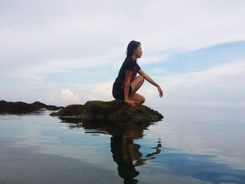 Woman jumping in water