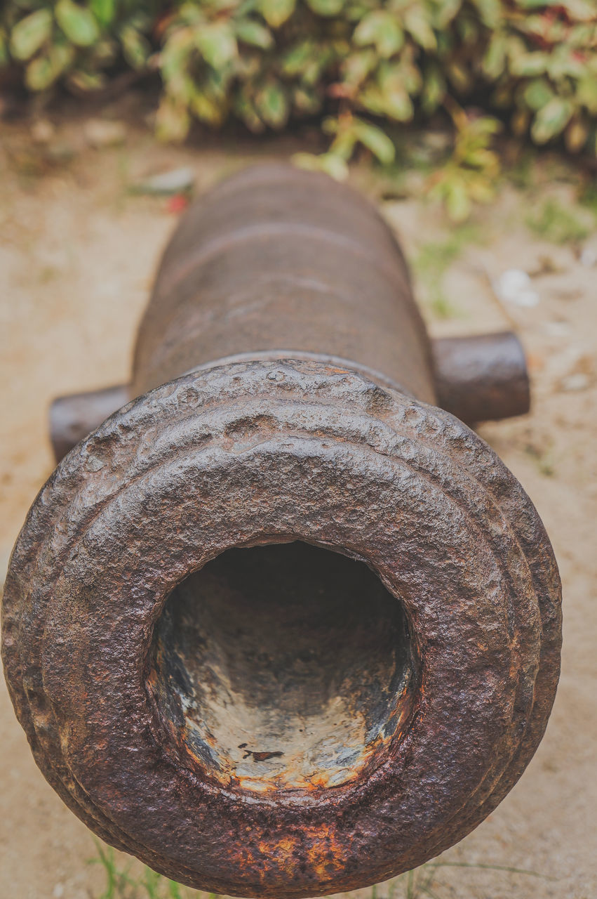 HIGH ANGLE VIEW OF OLD RUSTY METAL ON FIELD