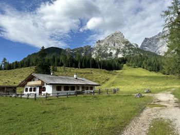 Houses on field against sky