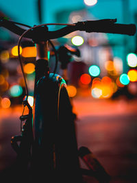 Rear view of illuminated lighting equipment on street at night