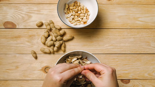 Cropped hand of person preparing food on table