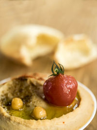 Close-up of hummus with bread on cutting board