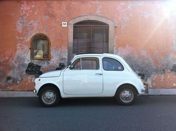 Vintage car on street against building