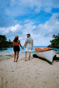 People on beach against sky