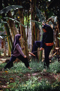 Side view of woman standing on field