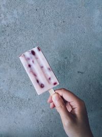 Close-up of hand holding ice cream