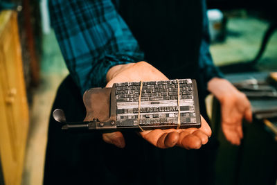 Detail shot of hand holding printing tool