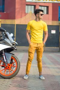 Rear view of man riding motorcycle on street