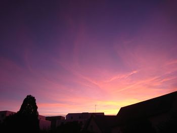 Silhouette buildings against sky during sunset