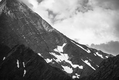 Low angle view of snowcapped mountain against sky