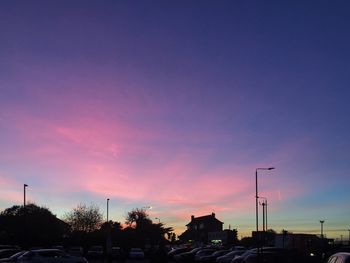 Silhouette city against sky at sunset