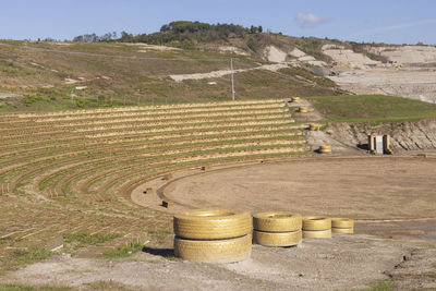 Modern amphiteater in foreground against the former landfill landscape