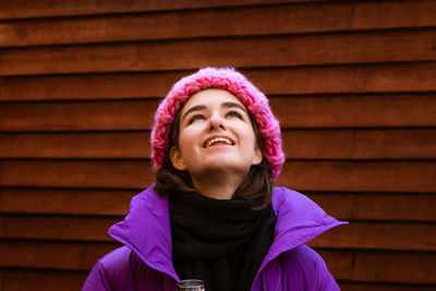 Beautiful caucasian young woman wearing snow clothes and holding a thermos