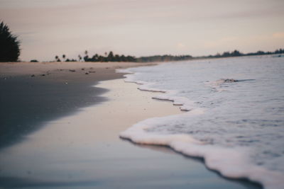 Scenic view of beach against sky during sunset