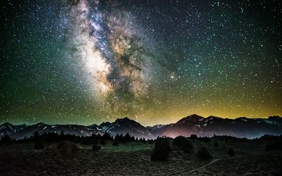 Scenic view of mountains against sky at night