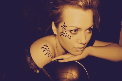 Close-up of woman against black background