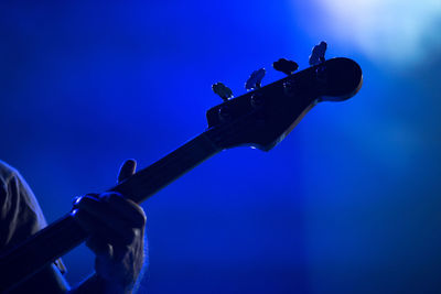 Cropped image of person using guitar