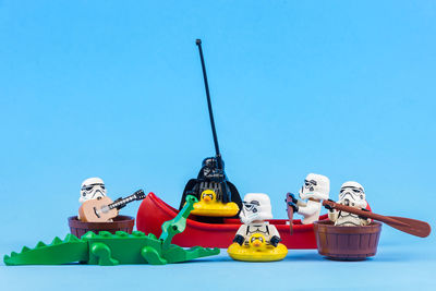 Low angle view of toys against blue sky