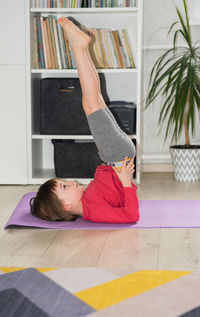 Low section of woman exercising in gym