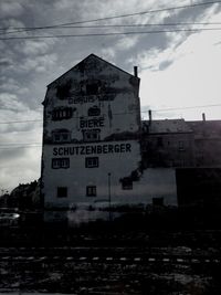 Buildings against cloudy sky