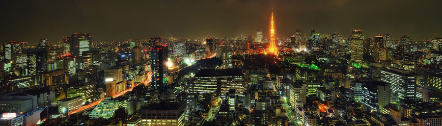 High angle view of illuminated modern buildings in city at night