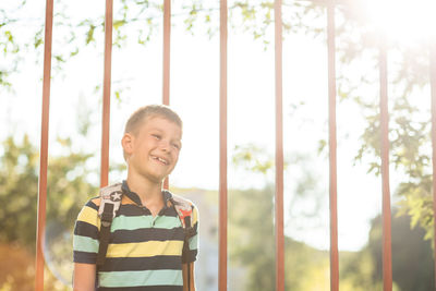 Smiling boy standing outdoors