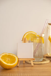 Empty painting canvas for you text mock up copy space glass of water with fresh lemon juice with