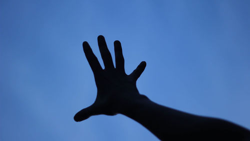 Silhouette of man against blue sky