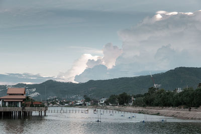 Scenic view of lake by buildings against sky