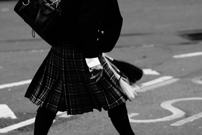 Midsection of person wearing kilt while walking on road