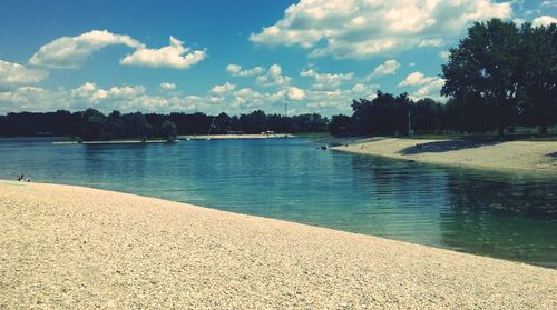 Scenic view of lake against cloudy sky