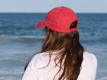 Rear view of woman wearing hat at beach