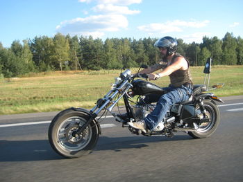 Man riding motorcycle on road