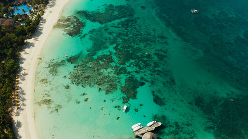 White sandy beach with tourists and hotels in boracay island, philippines